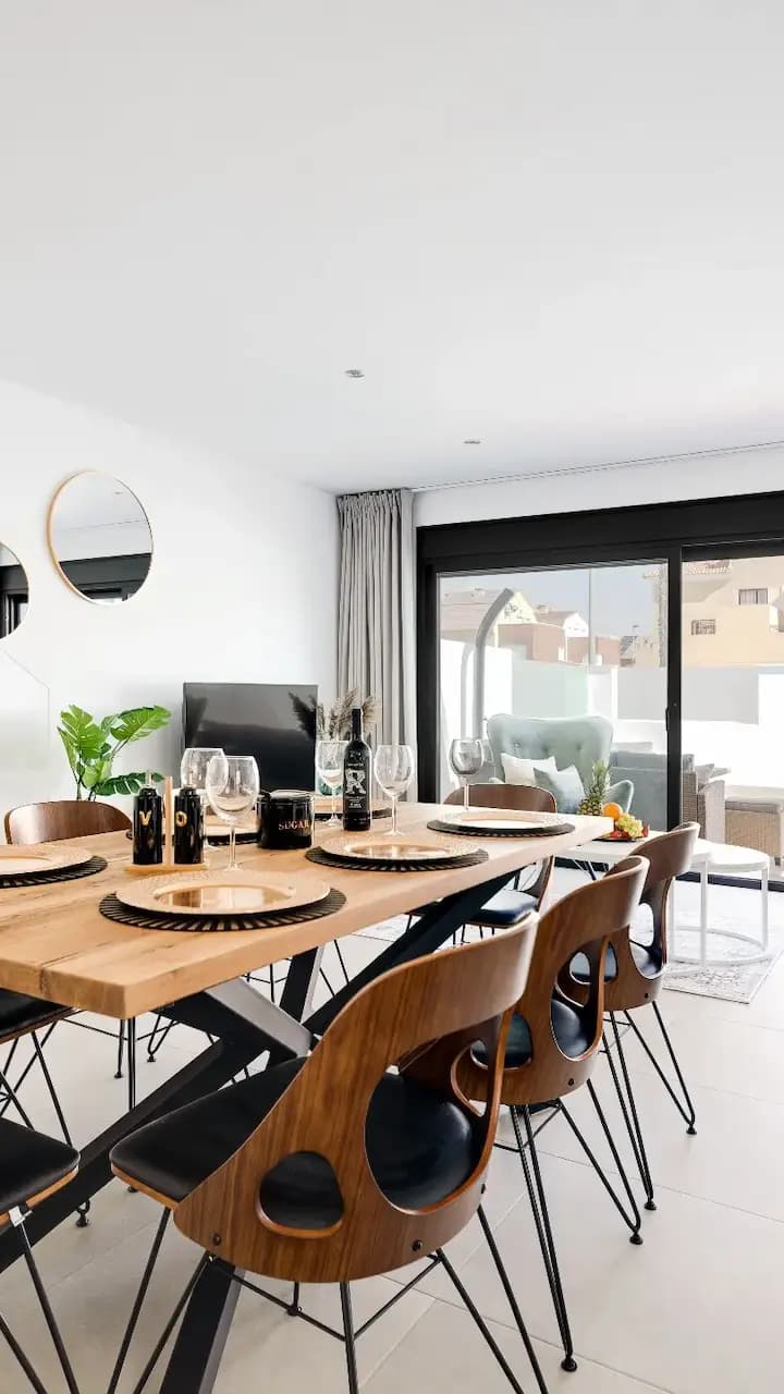 Clean and modern dining room setup with elegant furniture.