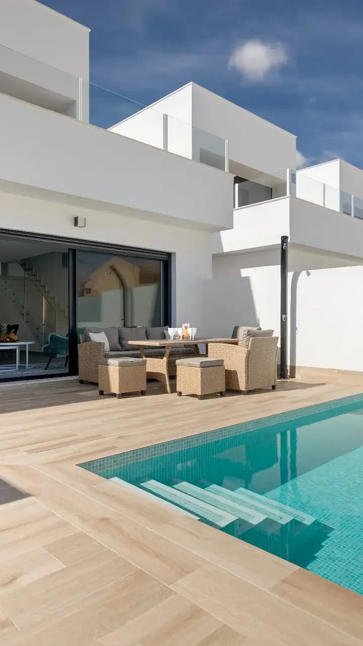 Stylish villa with swimming pool and patio, offering a serene and elegant outdoor space.