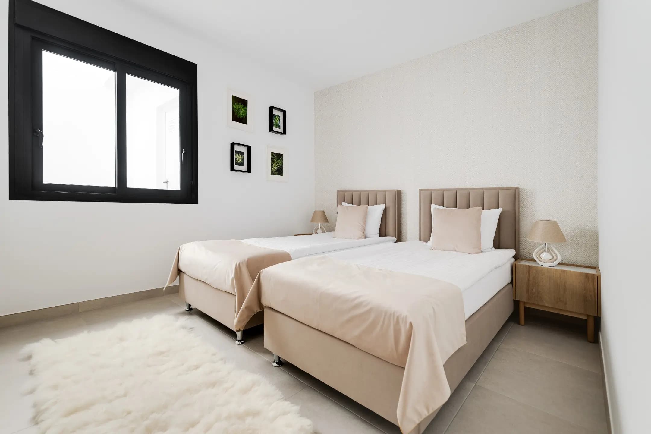 A cozy bedroom with two beds and a stylish rug, creating a comfortable and inviting atmosphere.